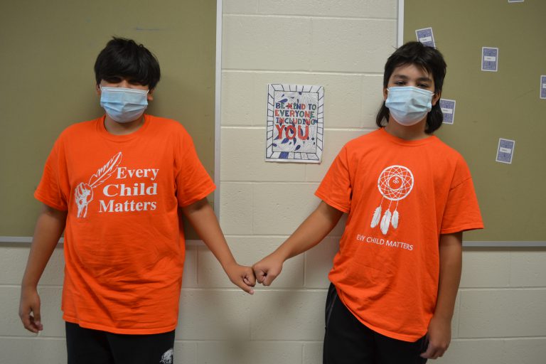 two boys doing a fist bump