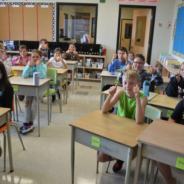 students give the thumbs up