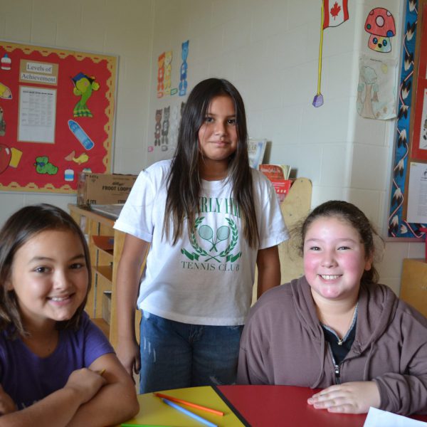 three indigenous students at table