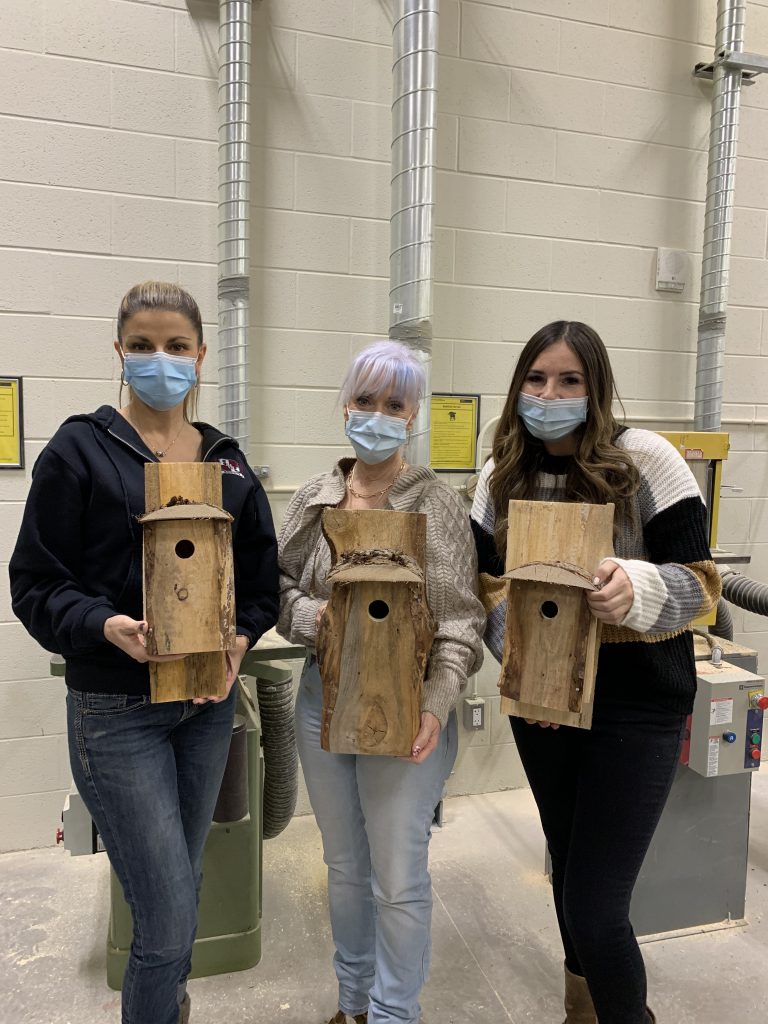 staff and students with birdhouses