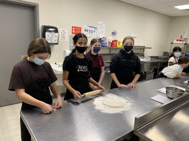 students rolling dough