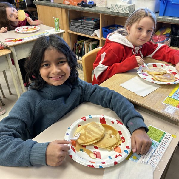Students eating pancakes on Shrove Tuesday