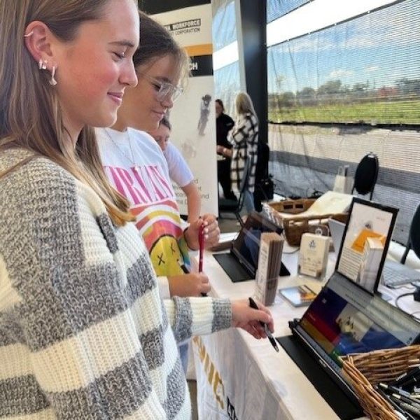 Two female students watching a video on a lap top