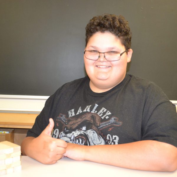male student gives the thumbs up sign