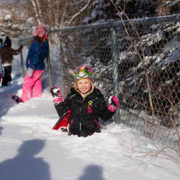 Student playing in the snow