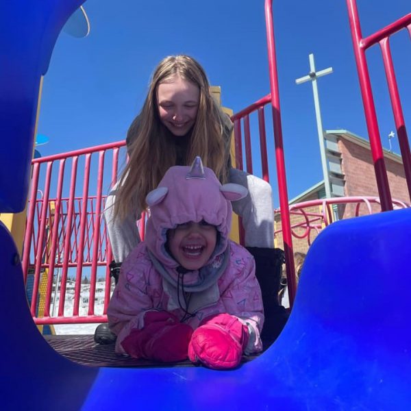 Students playing on the slide structure in schoolyard