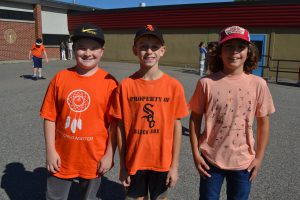 males students in orange shirts