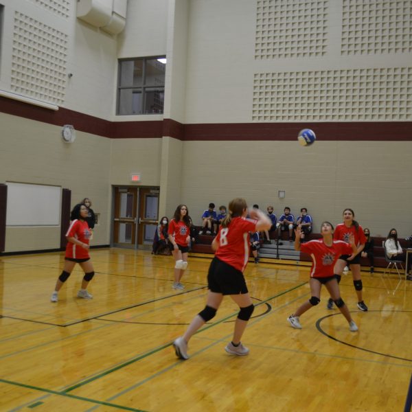 player looking up at a volleyball