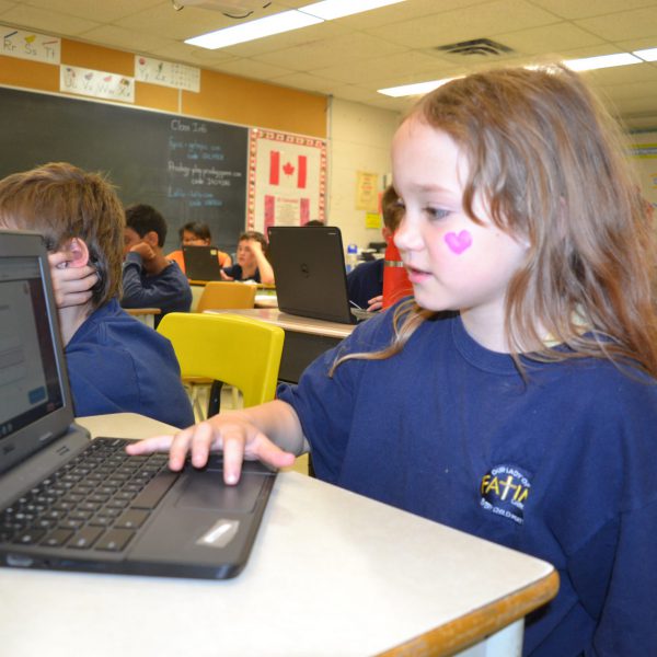 Female students uses a computer in the classroom
