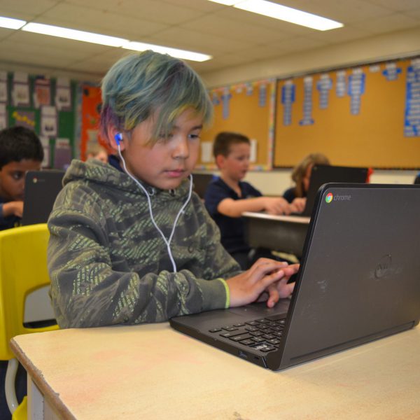 indigenous students uses a compuer in the classroom