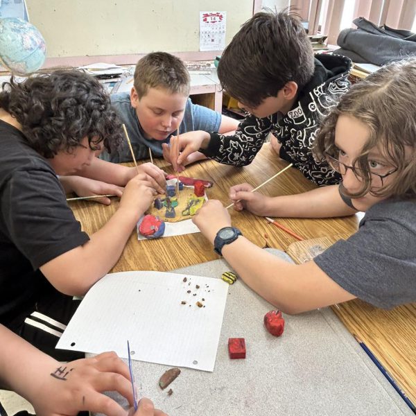 Students playing a math game at table