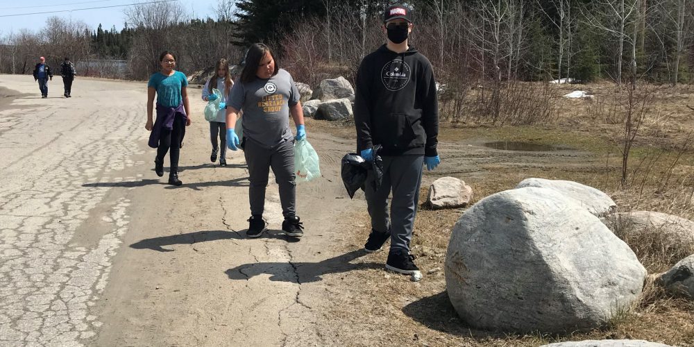 students collect roadside trash during Our Lady of Fatima Walk for Justice