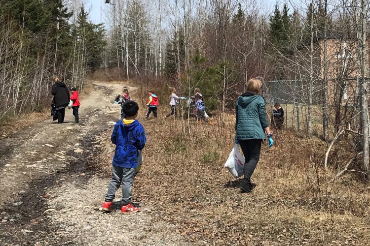 primary students at Our Lady of Fatima Catholic School collect garbage at the school perimeter