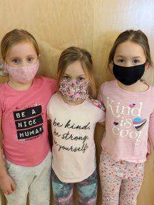 three girls wearing pink