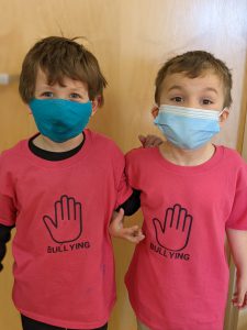 two boys with pink shirts