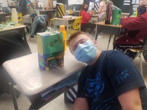 male student shows his leprechaun trap