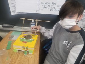 student beside his leprechaun trap