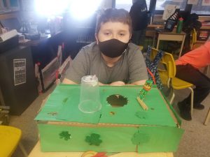 student sitting behind leprechaun trap