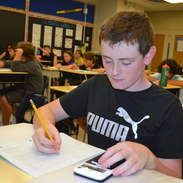 male student doing math work
