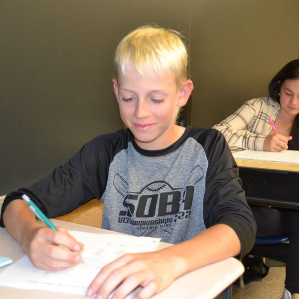 student writing at desk