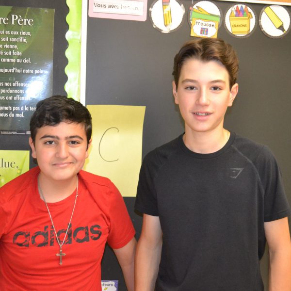 two male students in front of chalkboard