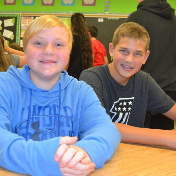 two students smile for the camera