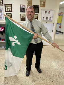 Principal Stephane Prevost holds Franco Ontarien flag