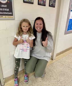 Student and staff member giving the thumbs up