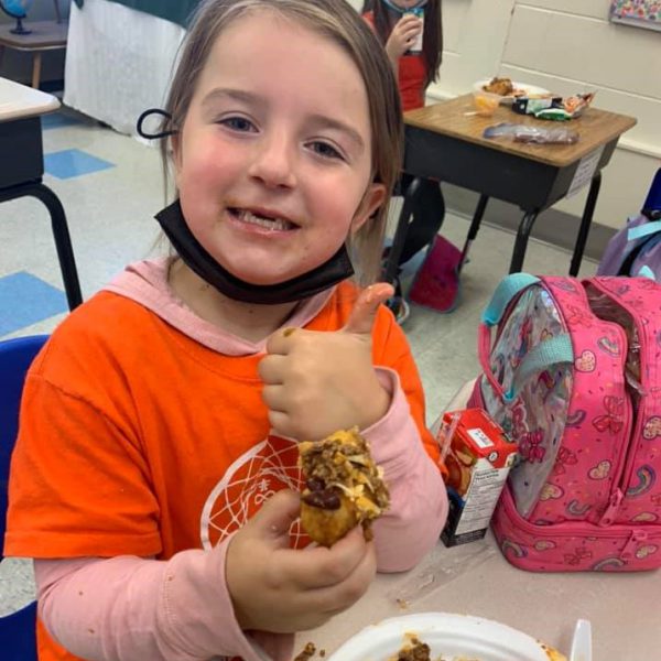 student giving thumbs up sign