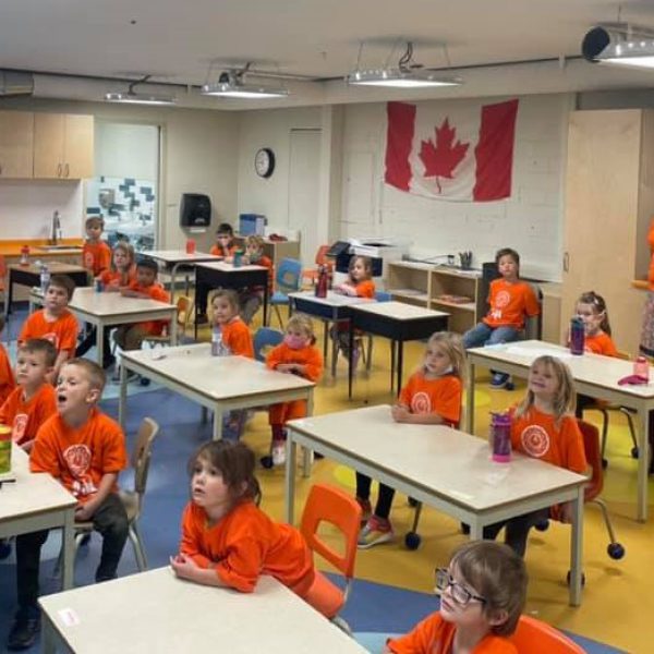 students in classroom wearing orange
