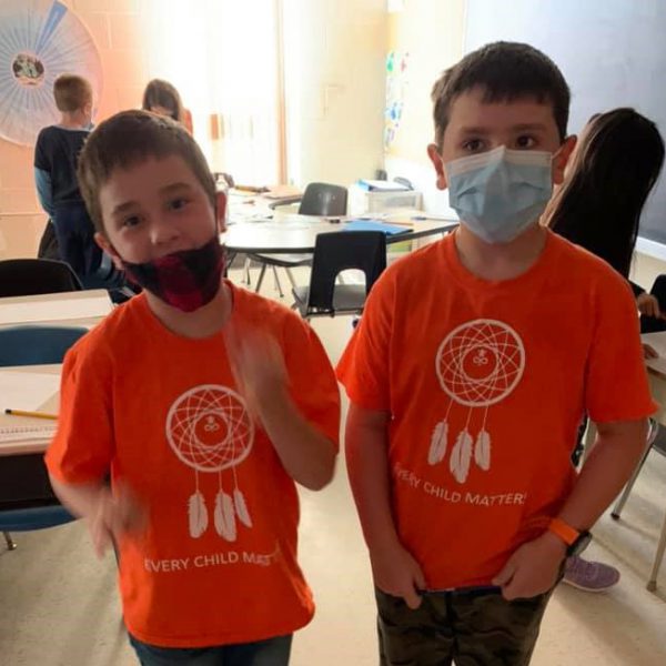 students in orange shirts