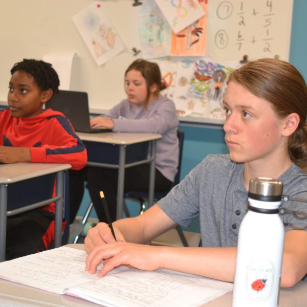 Students listen to teacher during lesson