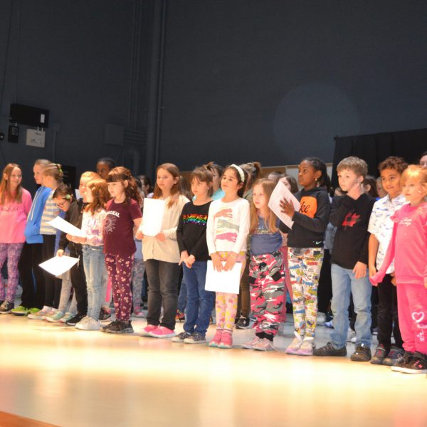 Students signing on stage