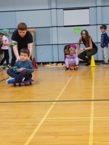 students in push race in gymnasium