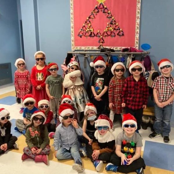 A group of students with Santa hats and sunglasses