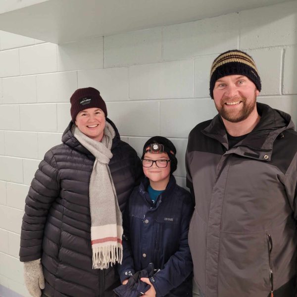 Parents with their child in foyer of St. Augustine French Immersion Catholic School
