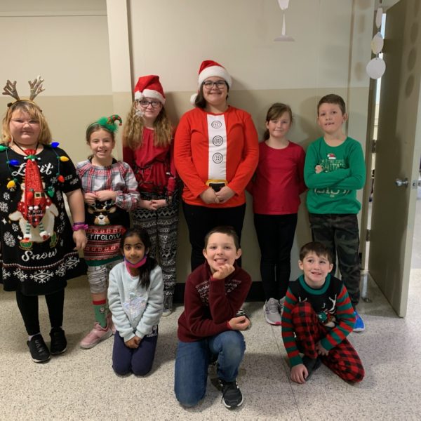 Students and staff showing off their Christmas sweaters