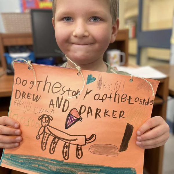 Students shows his artwork about a story he heard in class