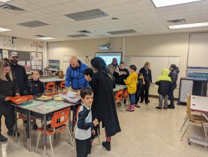 Parents mingling in a classroom