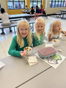Three students eating poutine