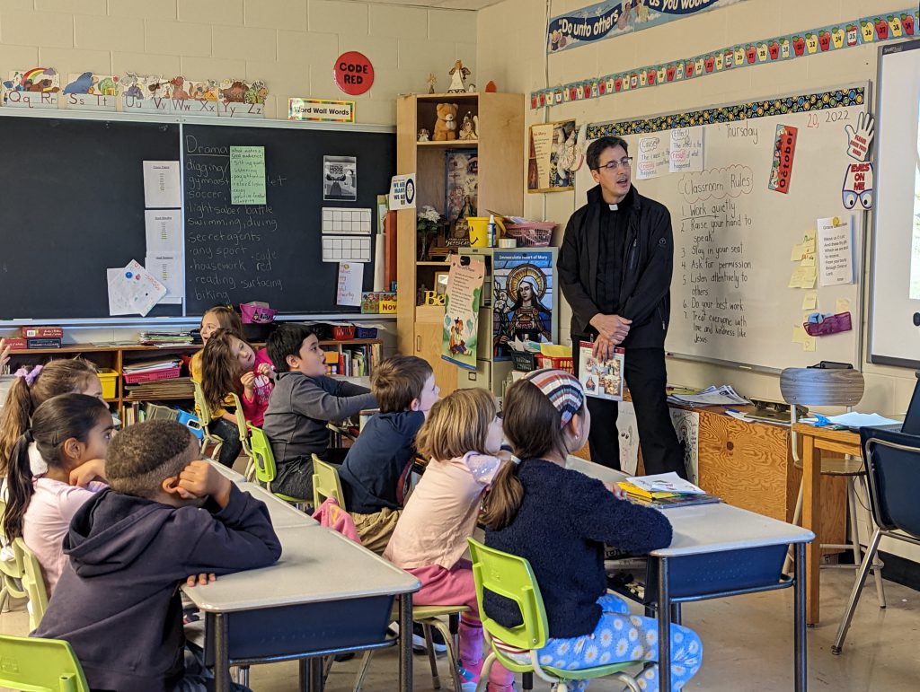 Father Shannon and students watching video