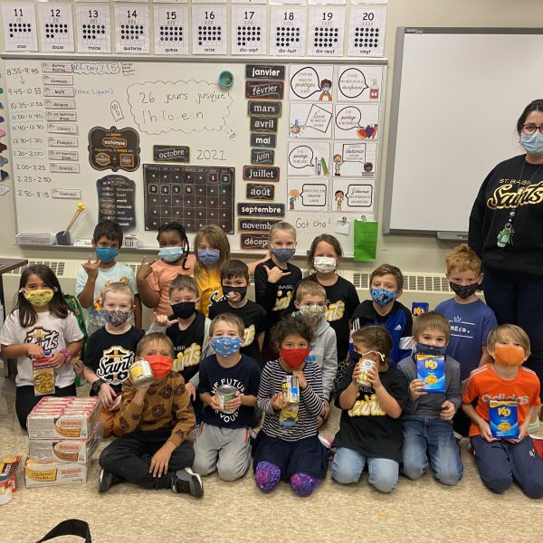Grade 1 and 2 students with food items