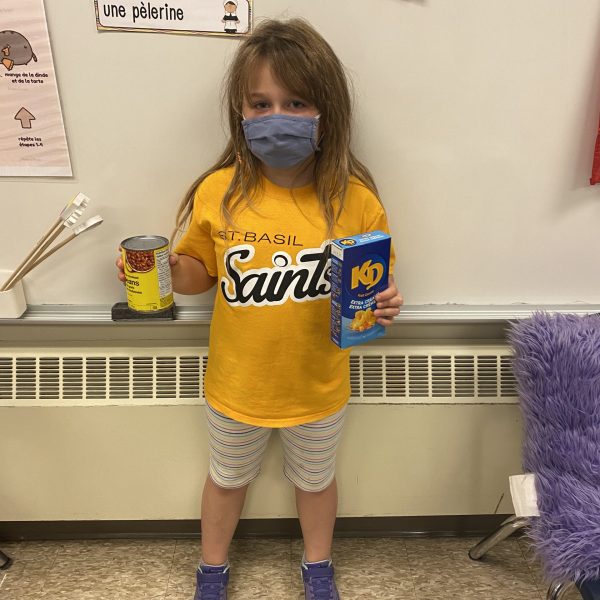 student holds food items.