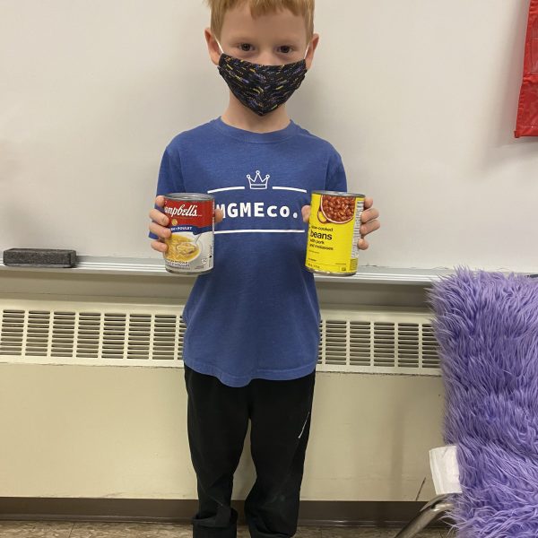 student with two cans of food