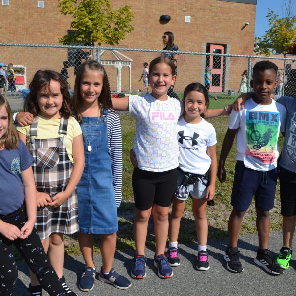 group of students in front of kindergarten play area