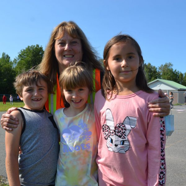 staff member and students in the yard