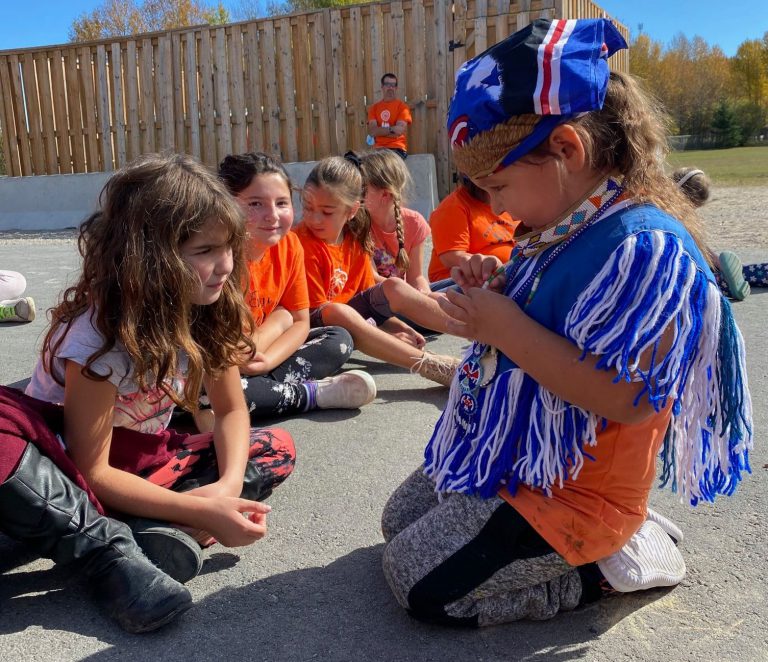 indigenous student shows bead necklace
