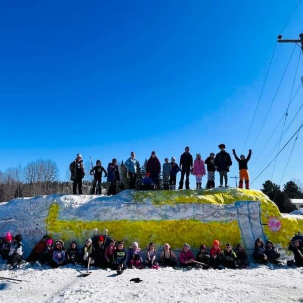 Students on their winter carnival snow sculpture