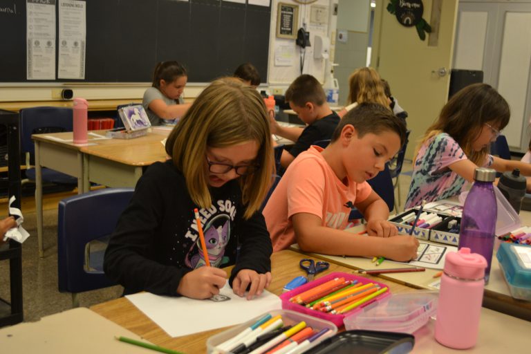 students colouring at desks