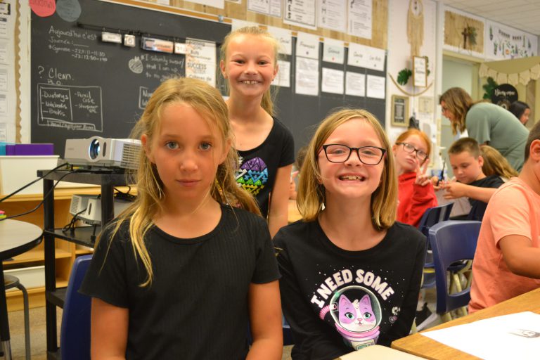 three students pose for a photo